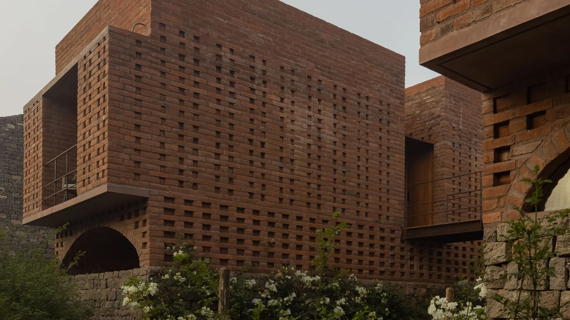 Ático’s brick building among the olive trees