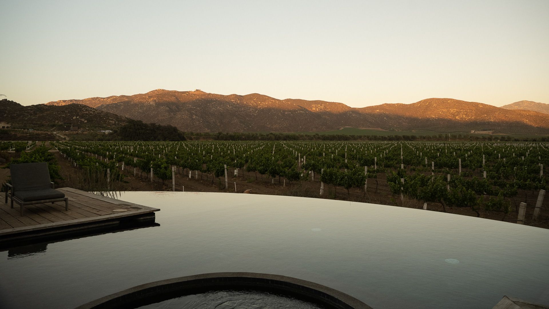 The pool at Bruma at dusk, with the vineyards and hills beyond
