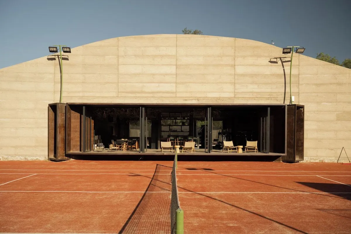 The Athletic Lounge opening onto its clay tennis court